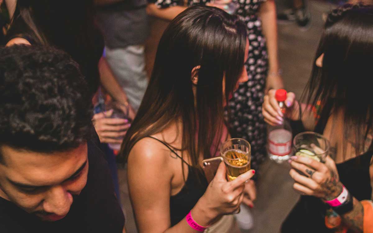 Guests wearing sponsor-branded event wristbands at a nightclub party in the U.S.
