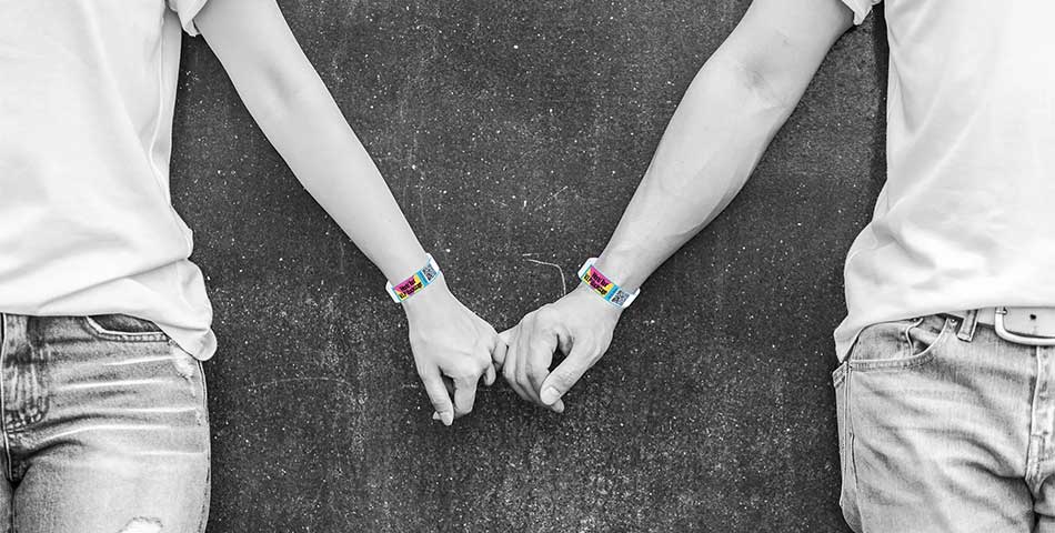 People wearing barcode and QR code wristbands for event entry scanning