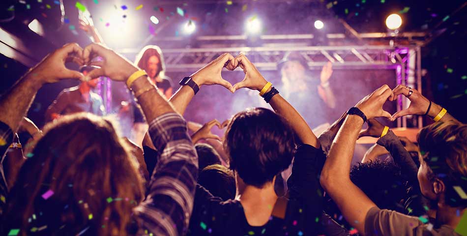 Festival crowd using RFID wristbands for access control, re-entry, and cashless payments