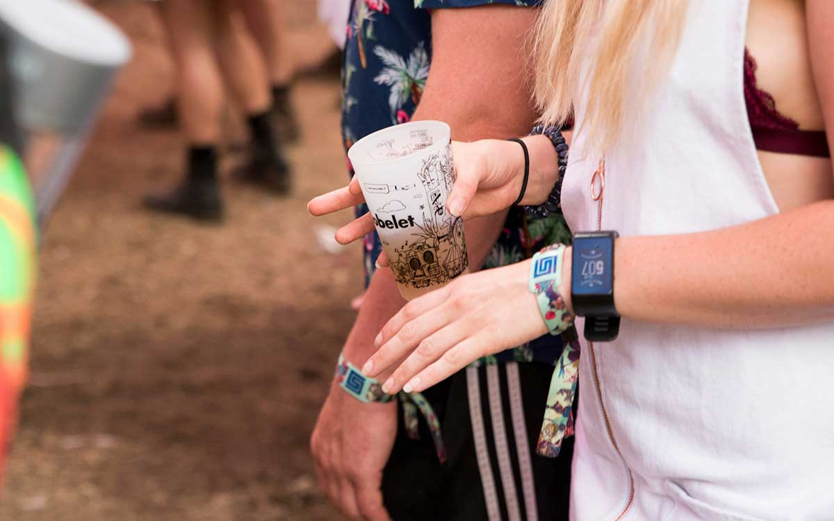 Festival attendee wearing custom cloth event wristbands for admission and access control at an outdoor event in the USA
